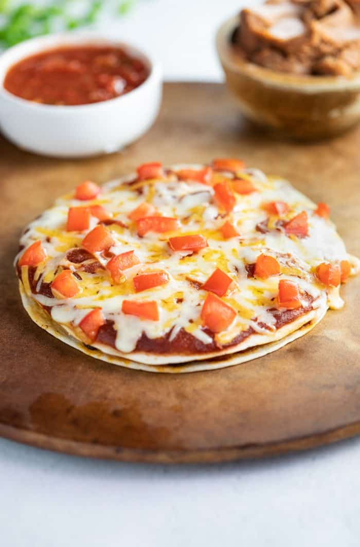 Whole Taco Bell Mexican Pizza on a pizza stone after being baked and before beings sliced. 