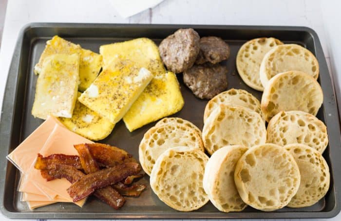 breakfast ingredients on a baking tray for making freezer breakfast sandwiches