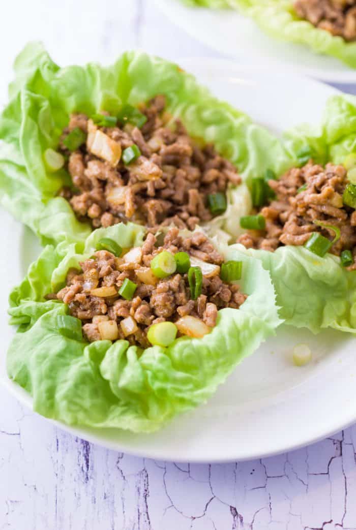 3 PF Chang's Chicken Lettuce Wraps on a white plate.