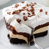 Peanut Butter Pie on a white plate with a fork taking a slice from it.