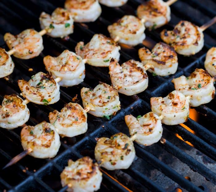 Lemon Garlic Shrimp on skewers cooking on the grill