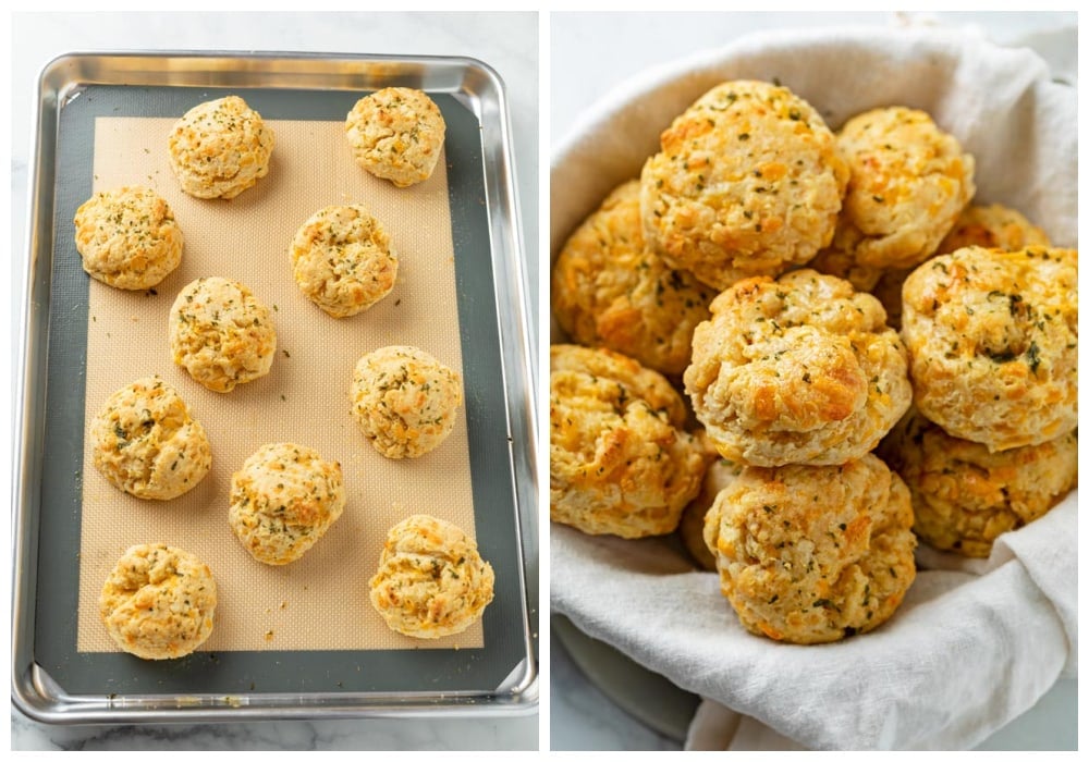 Cheddar Bay Biscuits on a baking sheet and in a basket with a cloth.