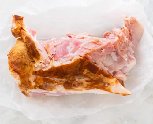 meaty ham bone on a white surface