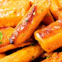 A close up of a pile of roasted carrots.