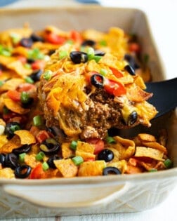 Taco casserole being scooped up from a casserole dish.