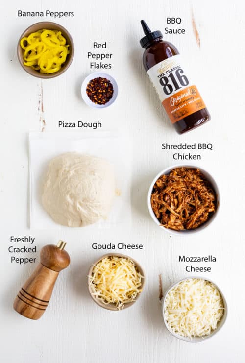 Ingredients on a white table for making BBQ Chicken Pizza
