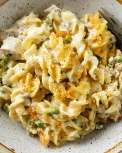 Tuna Noodle Casserole with Creamy egg noodles and peas in a bowl with a fork.