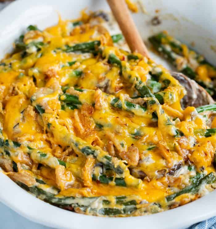 A close up look at warm green bean casserole topped with cheese.