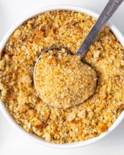 Homemade breadcrumbs in a bowl with a measuring spoon.