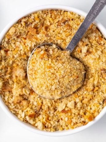 Homemade breadcrumbs in a bowl with a measuring spoon.