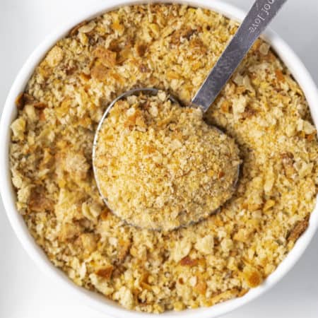 Homemade breadcrumbs in a bowl with a measuring spoon.