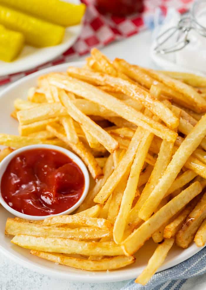 Copycat McDonald's French Fries on a white plate with ketchup.