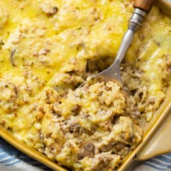 A casserole dish filled with cheesy ground beef and rice casserole.