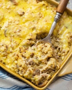 A casserole dish filled with cheesy ground beef and rice casserole.