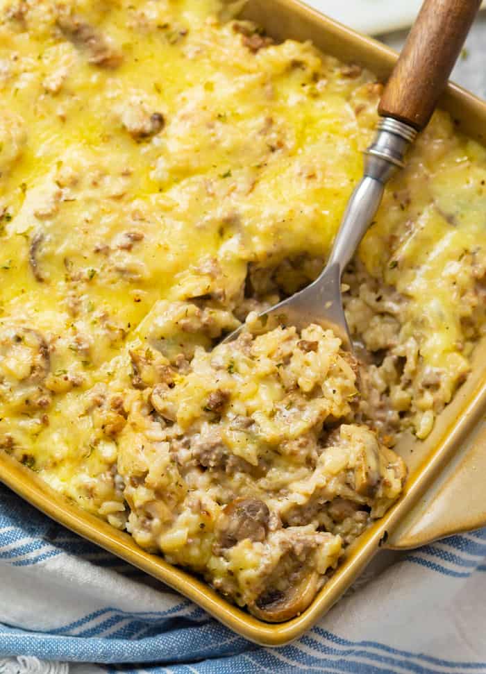 A casserole dish filled with cheesy ground beef and rice casserole.