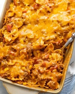 Sloppy joe casserole in a casserole dish with a spoon scooping it up.