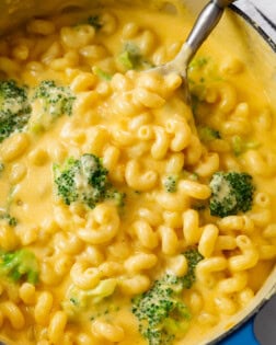 A dutch oven filled with Creamy Broccoli Mac and Cheese.