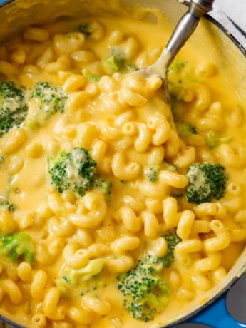 A dutch oven filled with Creamy Broccoli Mac and Cheese.