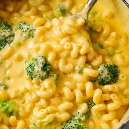 A dutch oven filled with Creamy Broccoli Mac and Cheese.