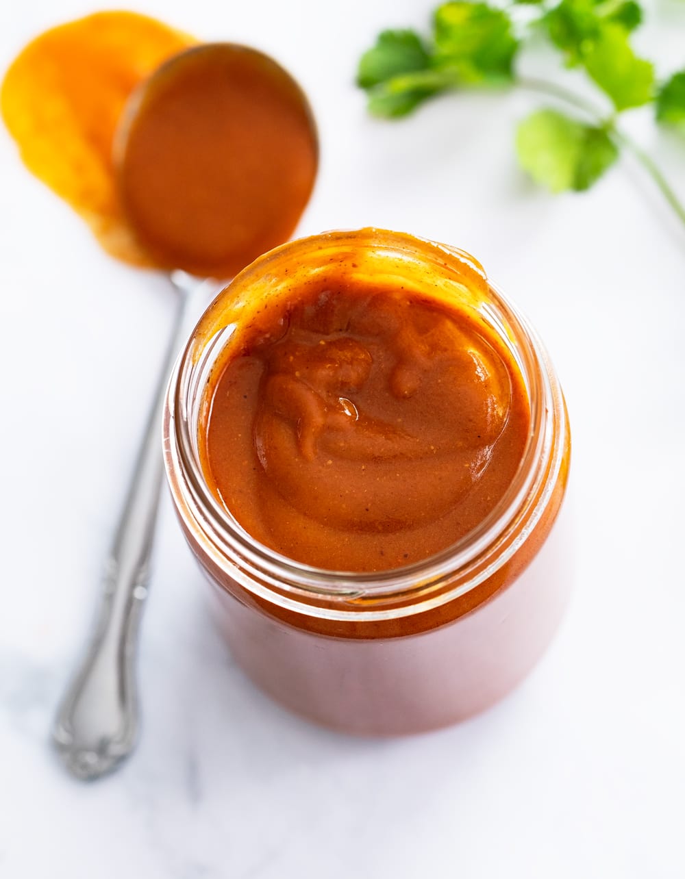 Overhead view of Enchilada Sauce in a glass jar.