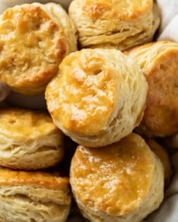 Golden Buttermilk Biscuits in a bowl with a cloth.