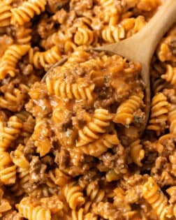 A wooden spoon full of creamy Ground Beef Pasta with Rotini noodles.