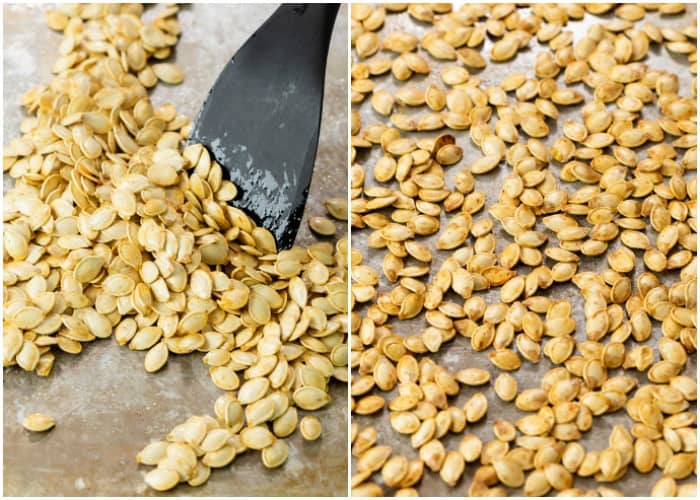 A spatula spreading pumpkin seeds on a baking sheet during roasting.