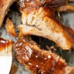 Tender Slow Cooker Ribs brushed with BBQ Sauce.