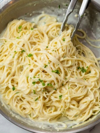 A skillet filled with creamy Garlic Parmesan Pasta topped with Parsley