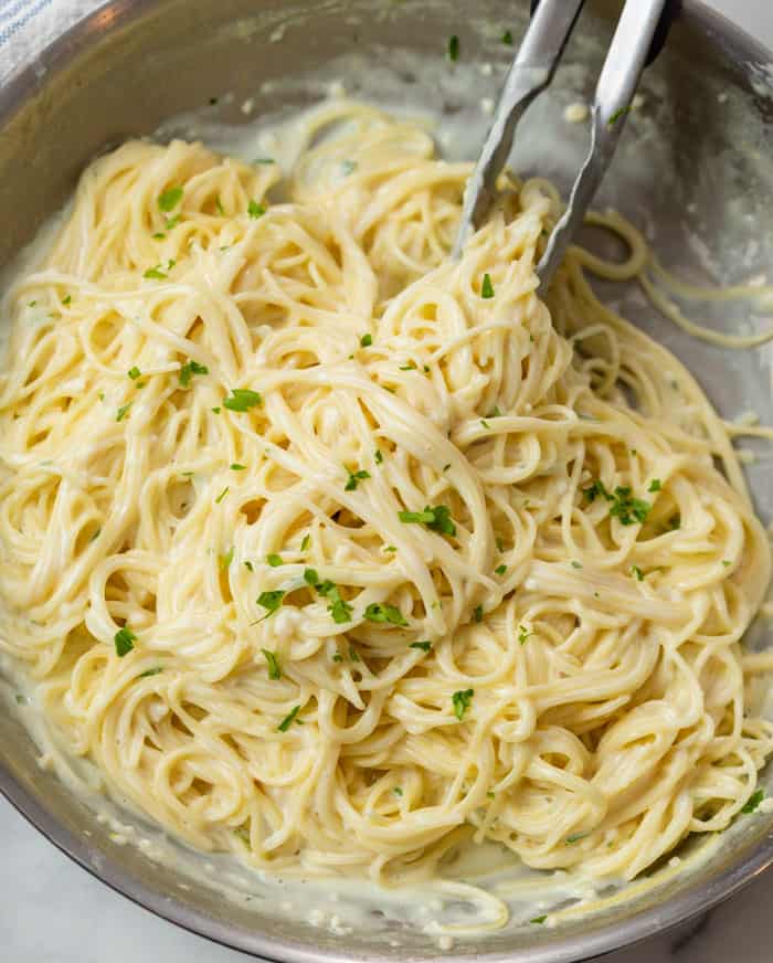 A skillet filled with creamy Garlic Parmesan Pasta topped with Parsley