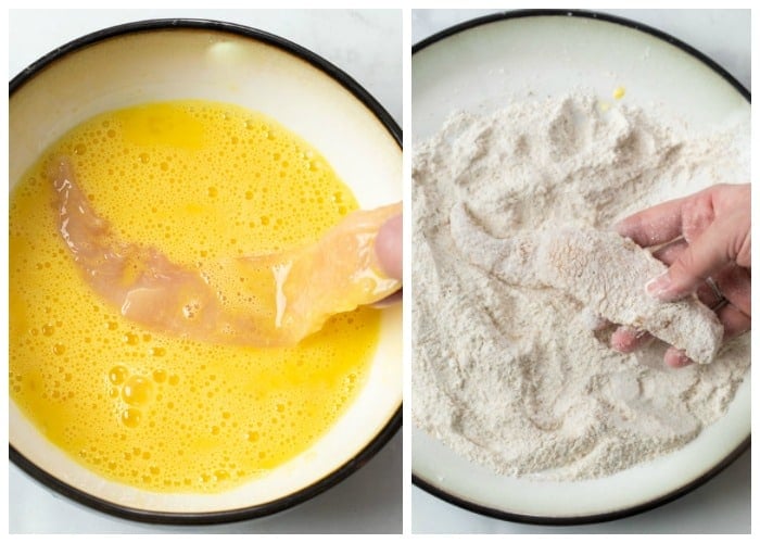 Coating a chicken strip in eggs and a flour breadcrumb mix before frying.