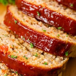 Turkey Meatloaf on a wooden surface cut into slices.