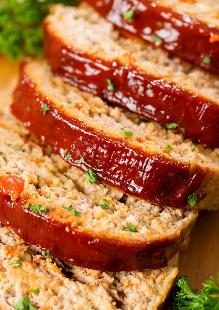 Turkey Meatloaf on a wooden surface cut into slices.