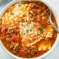 Lasagna Soup in a white bowl with a spoon on the side.