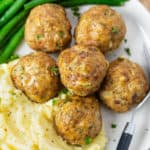 Turkey Meatballs on a plate with mashed potatoes and green beans.