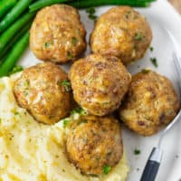 Turkey Meatballs on a plate with mashed potatoes and green beans.
