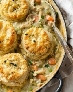 A skillet filled with Chicken Pot Pie topped with Golden Biscuits.