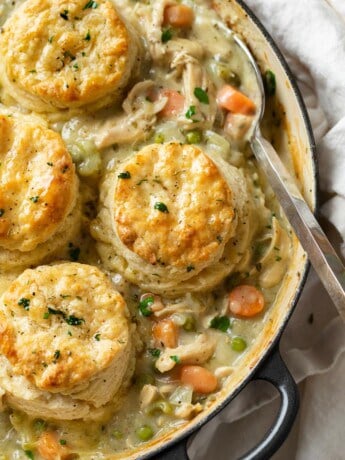 A skillet filled with Chicken Pot Pie topped with Golden Biscuits.