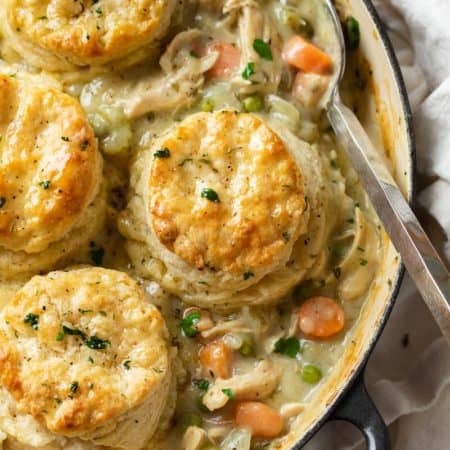 A skillet filled with Chicken Pot Pie topped with Golden Biscuits.