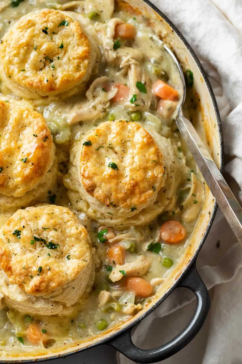 A skillet filled with Chicken Pot Pie topped with Golden Biscuits.