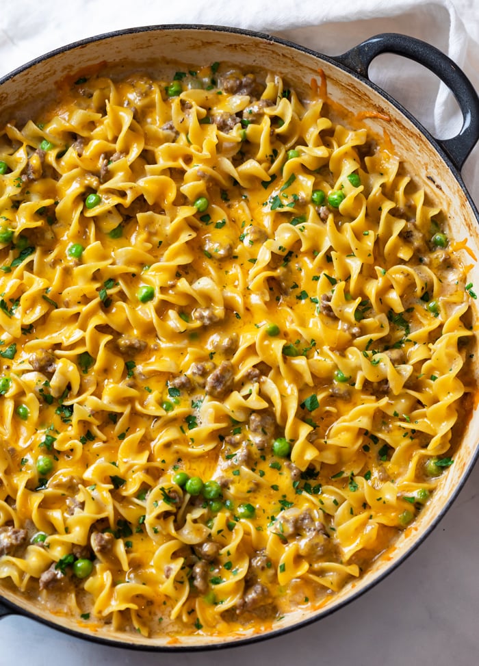 A pot full of Ground Beef Stroganoff topped with Cheese and parsley.