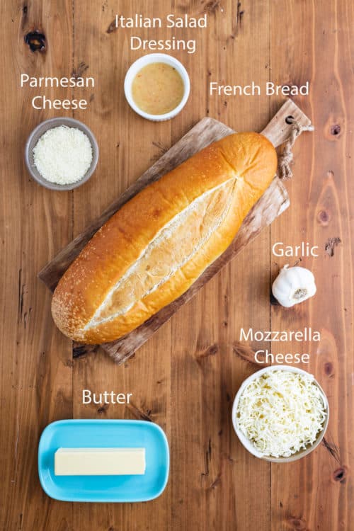 An overhead view of ingredients needed to make Garlic Bread with Cheese.