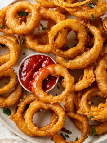 These homemade onion rings are deep fried in a flavorful batter and are so easy to make from scratch! Serve them with dipping sauce for fun appetizer idea.