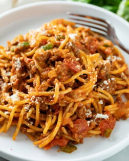 A white plate topped with One Pot Spaghetti in meat sauce.