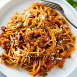 A white plate with One Pot Spaghetti in meat sauce.