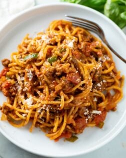 A white plate with One Pot Spaghetti in meat sauce.