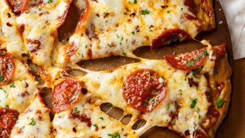 A Pepperoni Zucchini Crust Pizza on a pizza stone.