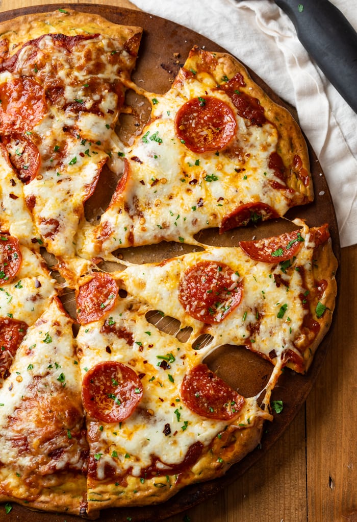 A Pepperoni Zucchini Crust Pizza on a pizza stone.