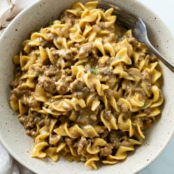 A bowl filled with creamy Beef and Noodles with a fork.