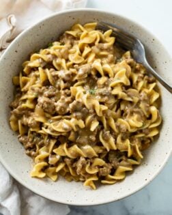 A bowl filled with creamy Beef and Noodles with a fork.